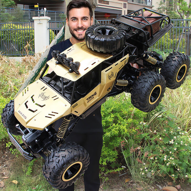 6-kołowy zdalnie sterowany Monster Truck w skali 1:12 | Możliwości terenowe | Zaawansowana technologia 2,4 GHz | Amortyzatory | Opony antypoślizgowe | Wysoka prędkość 52 km/h | Akumulator USB | Opcje czarno-złote